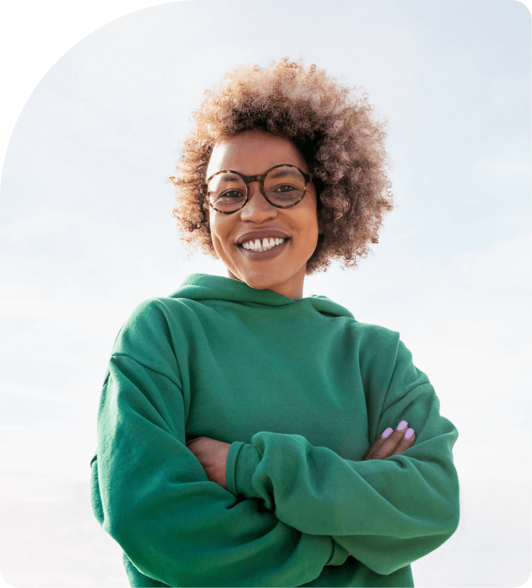 woman-with-afro-hair-smiling-with-arms-crossed-img-1